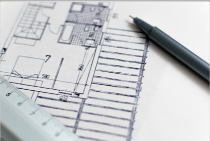 a black pen laying on blueprints